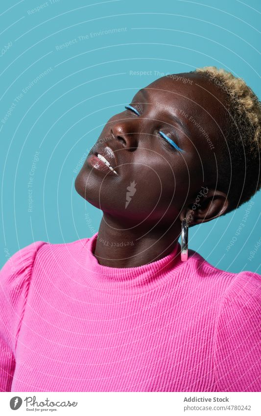 Portrait of a woman with face upwards style short hair dyed hair feminine trendy fashion hairstyle appearance female african studio eyes closed content optimist