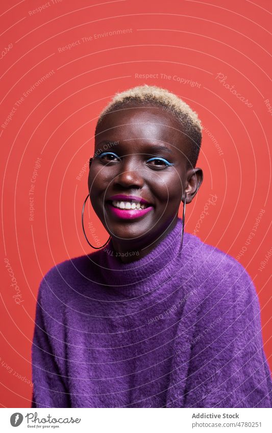 Cheerful African woman with short hair style dyed hair feminine trendy fashion hairstyle appearance female african studio smile positive charming vivid colorful