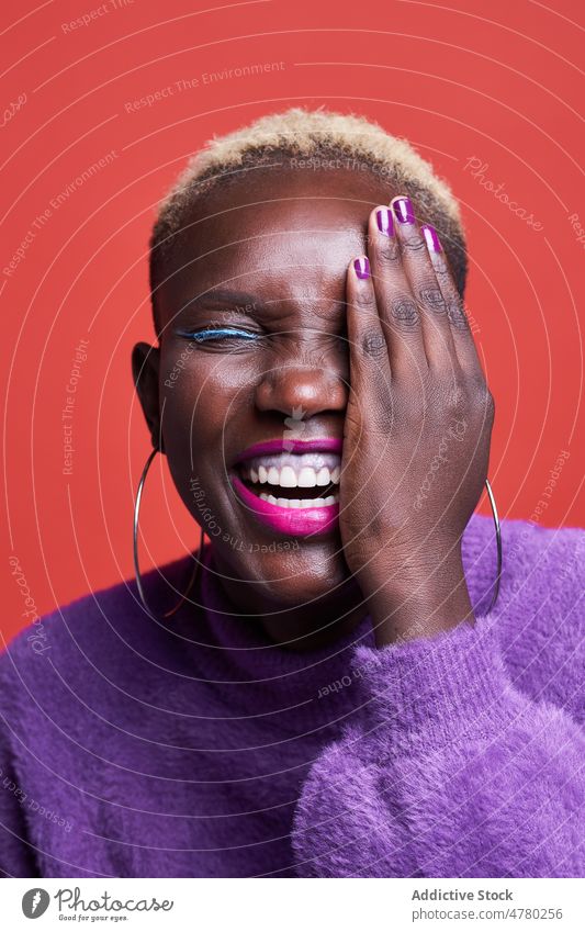 Calm African woman covering eye style short hair dyed hair feminine trendy fashion hairstyle appearance female african studio smile positive eyes closed content