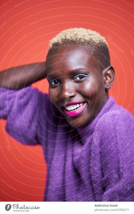 Happy African woman with short hair style dyed hair feminine trendy fashion hairstyle appearance female african studio smile positive content optimist glad