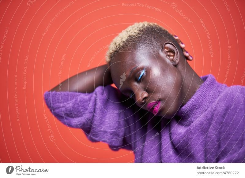 Peaceful African woman with short hair style dyed hair feminine trendy fashion hairstyle appearance female african studio eyes closed outfit lady garment color