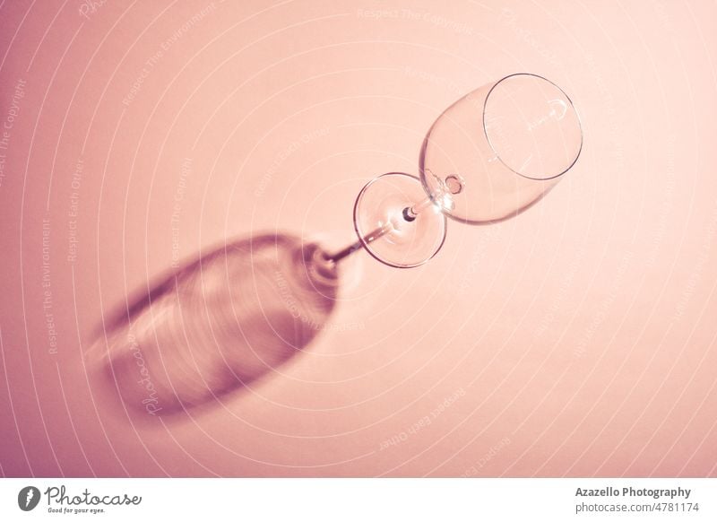 Empty wine glass with creative dark shadow on pink background. wineglass blue pastel pied calming coral base glassware goblet grape liquid luxury minimalism
