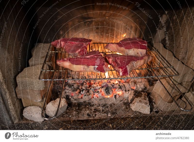 Barbecue Italian Fiorentina steak on the grill bbq chimney closeup cook cooking cow fire fireplace food fried grilled grilling home italian italy meal meet raw