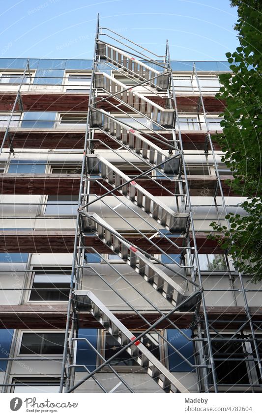 Modern scaffolding with iron and steel stairs during the renovation of the facade of a large building of the sixties and seventies in the Bornheim district of Frankfurt am Main in the German state of Hesse