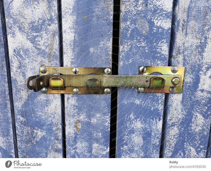 Locked blue wooden door, detail view Locking bar locked bolted and barred Detail closed door Wood Wooden board Blue board shed board wall Exterior shot Closed