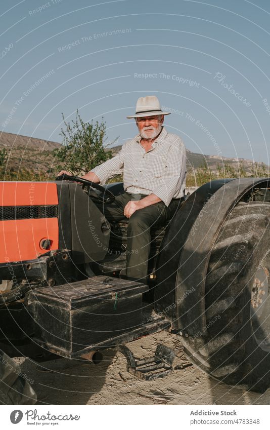Man on tractor in orchard man industrial tree farmer apricot plantation countryside industry bloom cultivate garden blossom agriculture flora transport summer