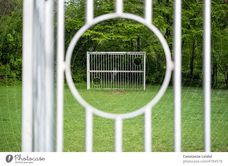 View through a circular recess of a soccer goal to the opposite goal. Foot ball Sports Playing Goal Playground Outdoors Green (Green) Soccer Goal