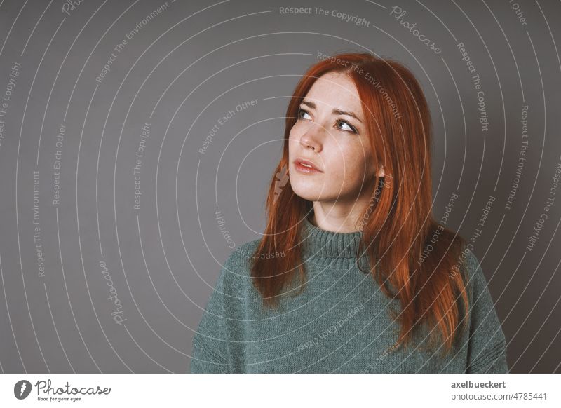 thoughtful woman in turleneck sweater is looking up thinking or planning question contemplation pensive imagination copy space doubt serious solution indoor