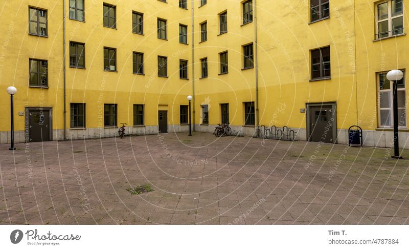 Ugly yard in yellow in Berlin Yellow Backyard Communication Interior courtyard Hideous Window House (Residential Structure) Facade Town Deserted Downtown