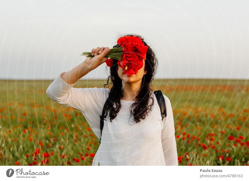 Portrait of girl covering face with poppies Portrait photograph portrait Girl Woman Poppy Poppy blossom Poppy field Summer Flower Blossom Exterior shot Nature