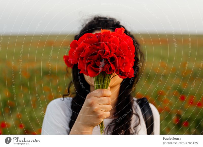 Portrait of girl covering face with poppies Portrait photograph portrait Girl Woman Poppy Poppy blossom Poppy field Summer Flower Blossom Exterior shot Nature