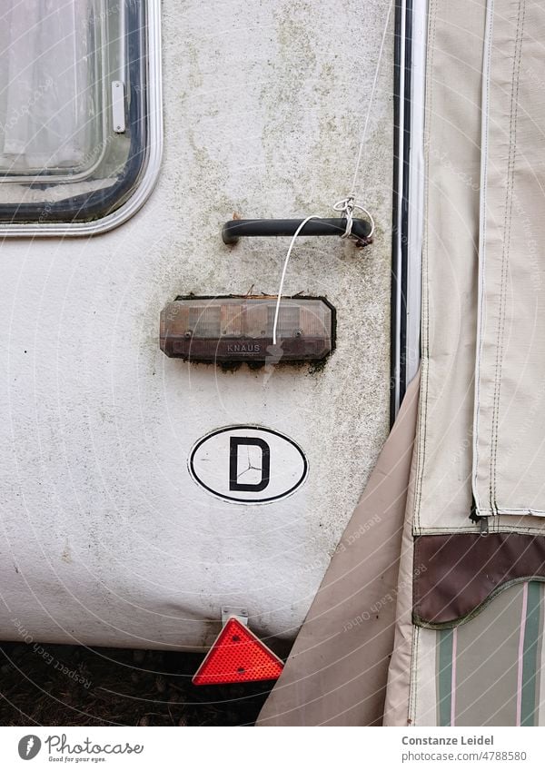 Detail view of old caravan with D sign. Caravan Camping Vacation & Travel Mobility Tourism Summer vacation Leisure and hobbies Relaxation Lifestyle Camping site