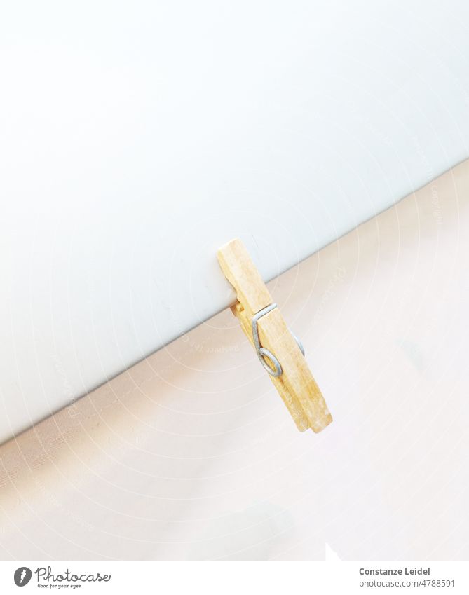 Wooden clothespin on white and rose background Hang Household Holder Washing day Hang up Clean Fresh Photos of everyday life Dry Summer Minimalistic