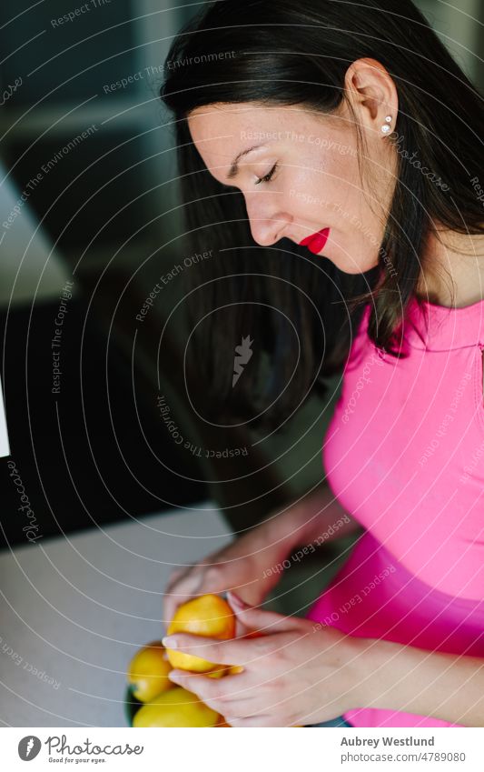 woman puting lemons in a bowl in her kitchen apple banana calories care caucasian channel chef citrus cooking cut cutting board cutting fruit demonstration