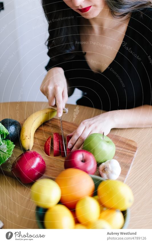 woman cutting fresh fruits on a wood cutting board apple banana calories care caucasian channel chef cooking cutting fruit demonstration detox diet dietician