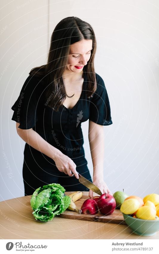 dark haired woman cutting vegetables and  fruits on a cutting board apple banana calories care caucasian channel chef cooking cutting fruit demonstration detox