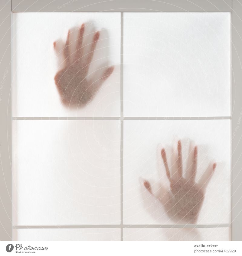 silhouette of hands trapped behind translucent screen shadow person mystery window female woman white adult touch fear horror japanese transparent crime escape