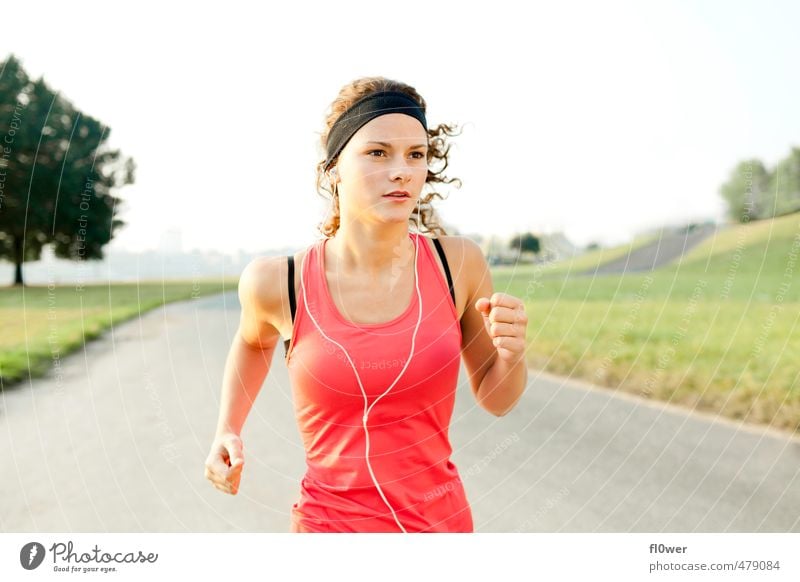 Woman jogging on asphalt road in nature with headphones Sports Feminine Young woman Youth (Young adults) 1 Human being 13 - 18 years Child 18 - 30 years Adults