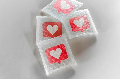 Packaging social Likes icon with bubble wrap audience buy care collection communication community concept conceptual container delivery fragile grow heart