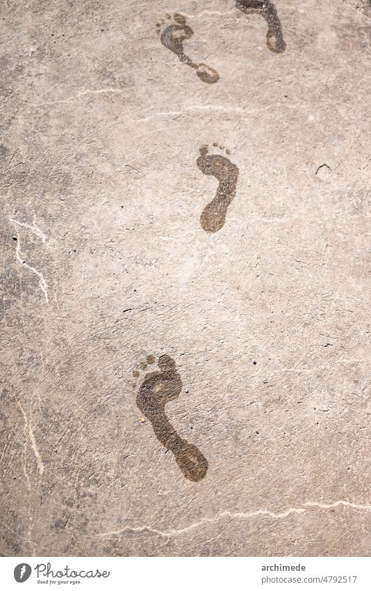 Wet footprint on the asphalt feet imprint nobody summer walk wet
