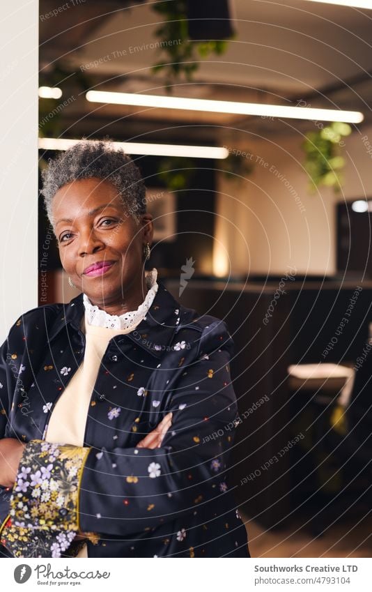 Portrait of senior black woman with arms folded looking at camera with confident expression in coworking space portrait office indoors day one people authentic