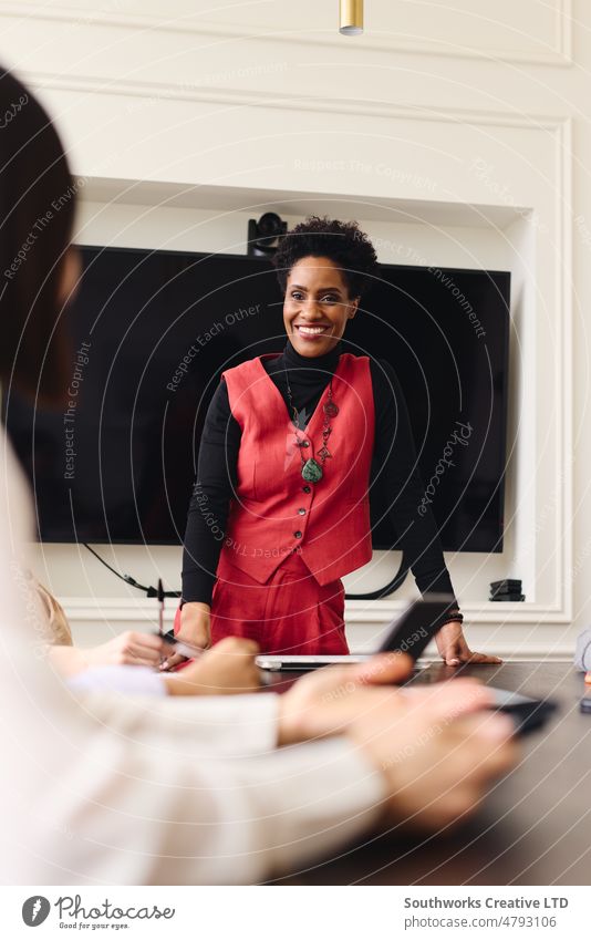 Portrait of mature black businesswoman in meeting with confident and cheerful expression portrait smile two adult indoors day people authentic international