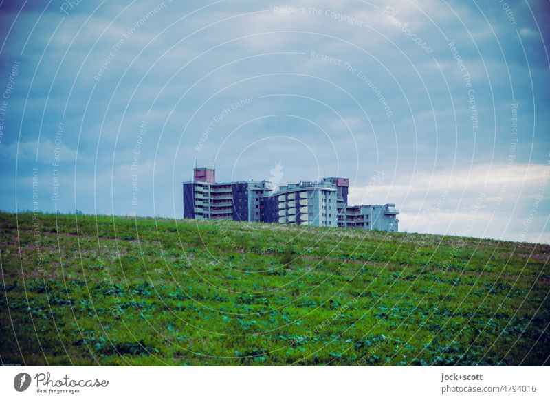 Suburban settlement, green hill and blue clouds Hill Tower block Outskirts illusive Meadow Environment Landscape wide Sky Clouds Climate Panorama (View) Nature