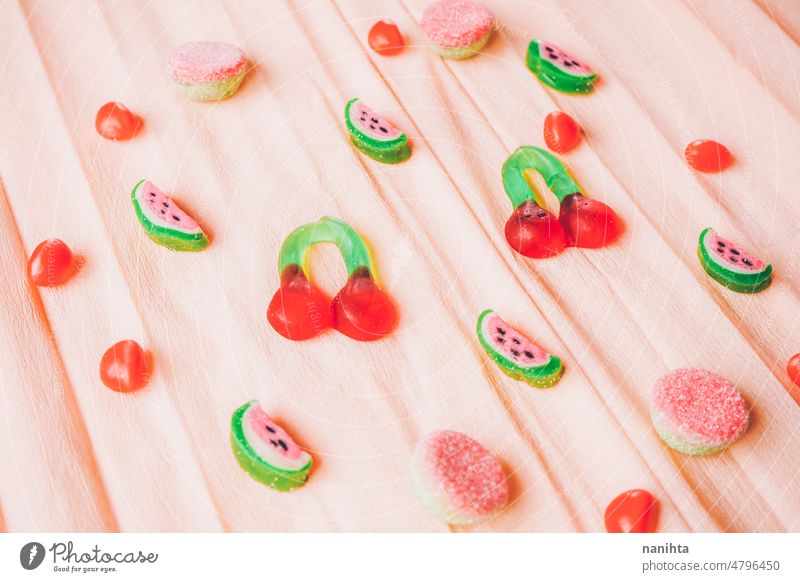 Fruits jelly beans over a salmon colored paper background sweet summer coral temptation delicious cherry watermelon candy bittersweet sweet and sour pink