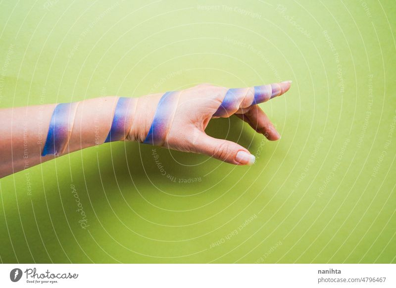 Conceptual image about an obligation concept conceptual hand trapped point background washi tape green surrounded skin arm finger delicate fragile captured