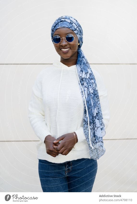 Happy stylish black woman in headscarf and sunglasses smiling at camera portrait smile self assured style cool fashion happy content charismatic trendy