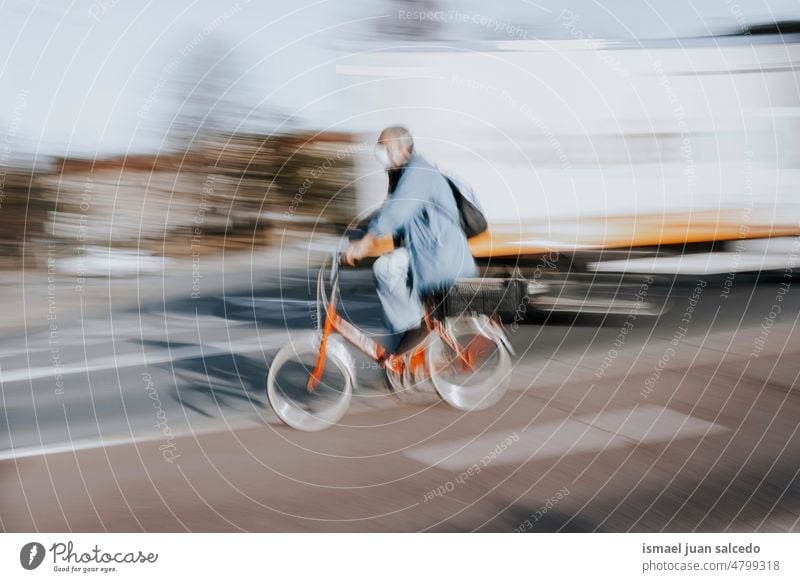 cyclist on the street mode of transportation in bilbao city, spain biker bicycle cycling biking exercise activity lifestyle ride speed fast blur blurred motion