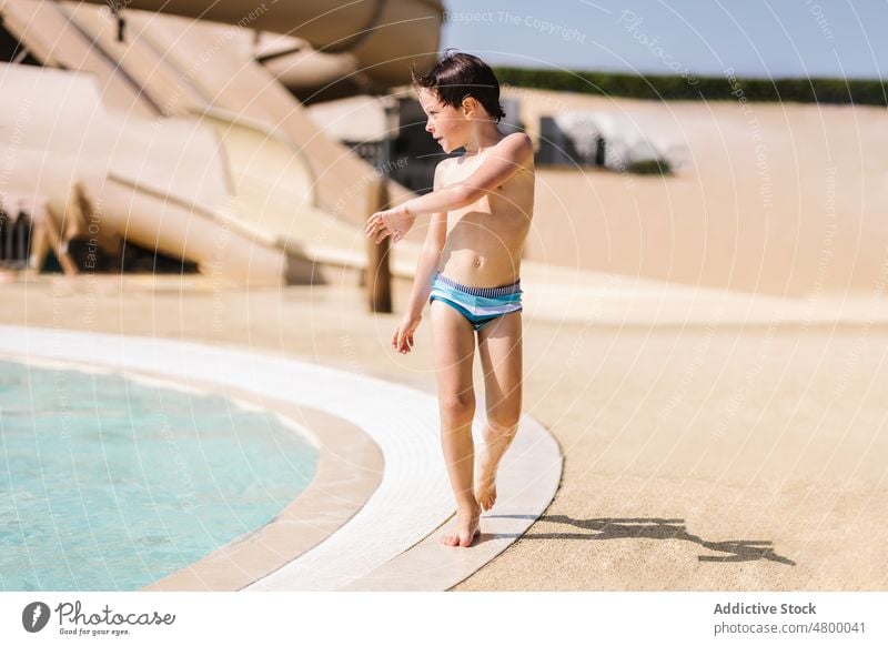 Little boy standing near swimming pool on sunny day - a Royalty Free Stock  Photo from Photocase