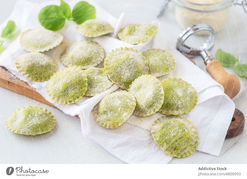 Fresh homemade ravioli with basil dough aroma aromatic cheese cooking cuisine delicious dinner durum filled food fresh gluten green cutting board napkin herb