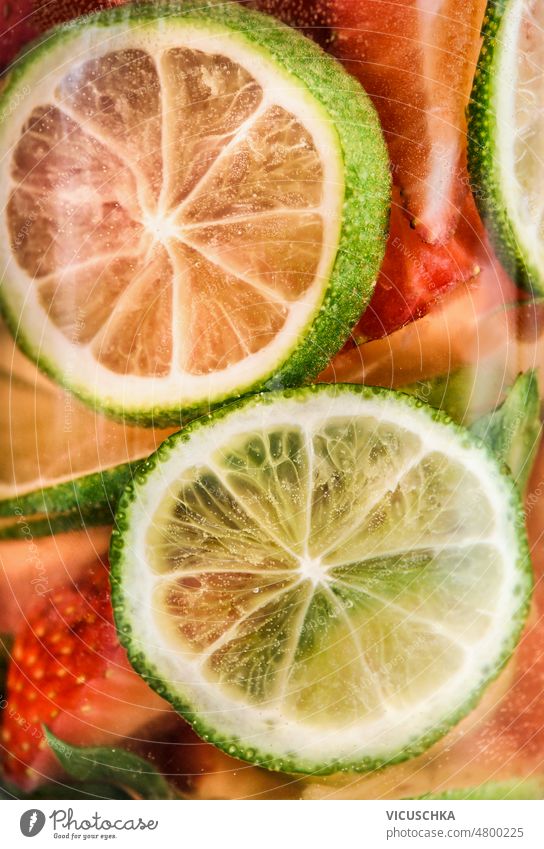 Close up of infused water with  lime and strawberry. close up summer refreshing drink fruits healthy lifestyle front view bottle freshness glass bottle
