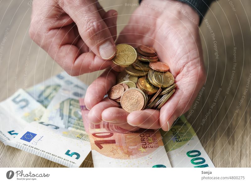 A man holds euro coins in his hands Coin Euro Bank note Hand Man stop Money Loose change finance Save Coins Financial Industry Income Paying Luxury investment