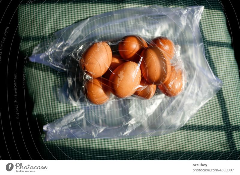 eggs in the transparent plastic bag white background organic package protein ingredient brown closeup raw healthy group product market container eggshell