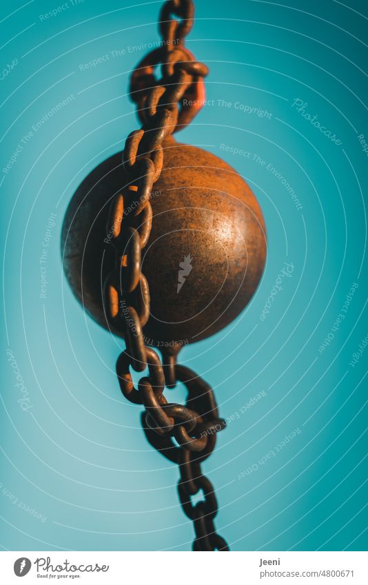 Iron ball Sphere Iron chain Chain Chain link corroded Rust rusty Sky Blue Complementary colour russet Connection Strong Heavy Force Hang Old Attachment Close-up