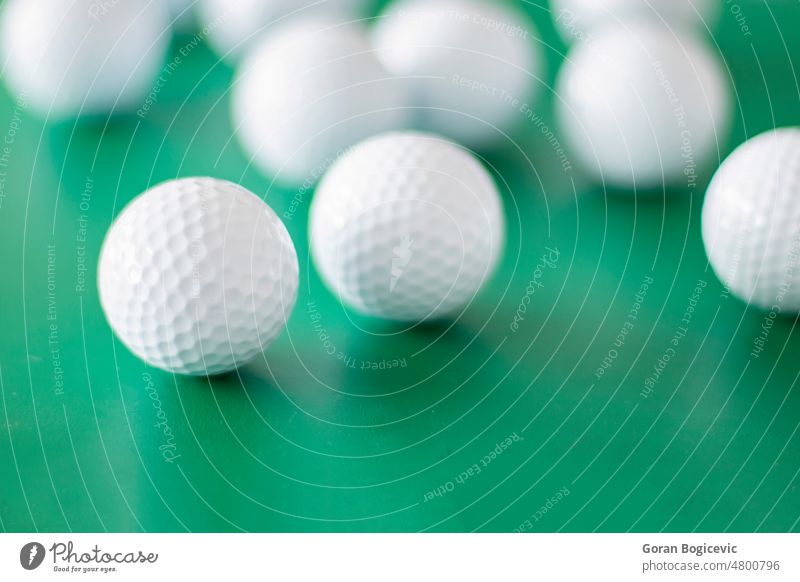 Golf balls on the green background bright circle closeup competition detail equipment fun game golf golf ball golfing hobby leisure object one playing
