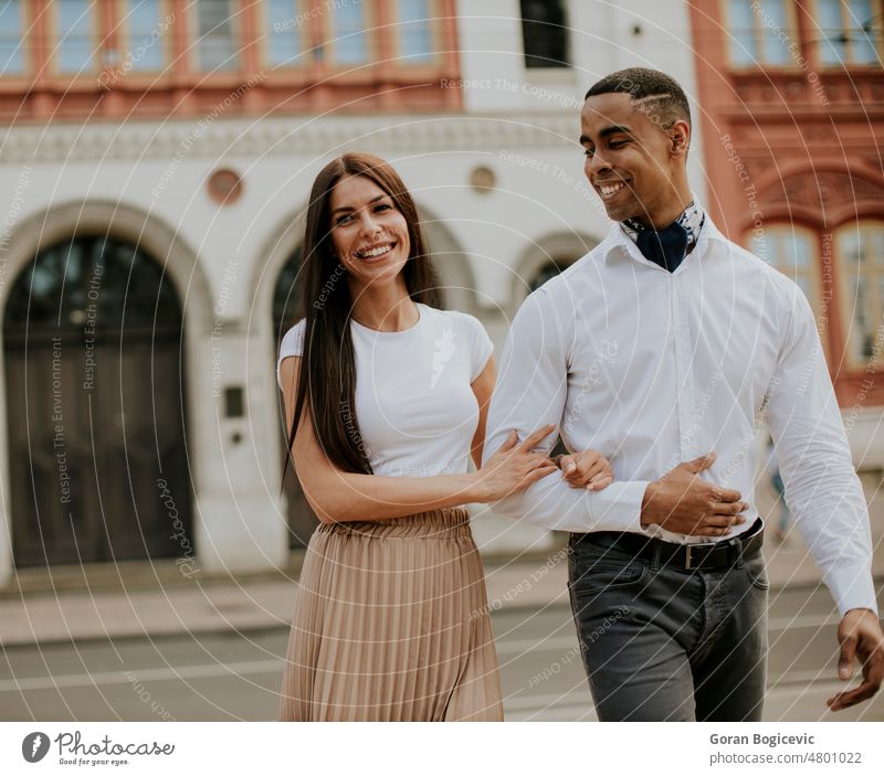 Young multiethnic couple walking on the street adult american attractive beautiful black boyfriend carefree casual caucasian city embracing enjoying female fun