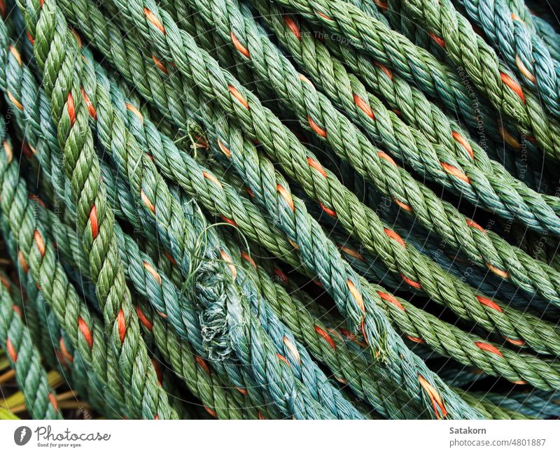 Roll of green nylon rope braided coil circle detail equipment fiber fibre line material plait plaited polypropylene roll strap strength spiral strong synthetic