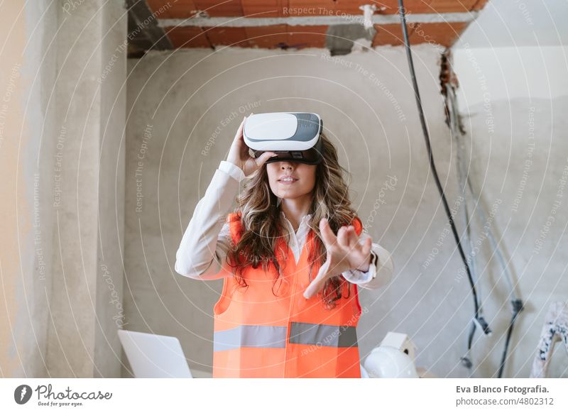 architect woman in construction site using virtual reality goggles working on VR blueprints inspector forewoman technology kitchen checking home laptop
