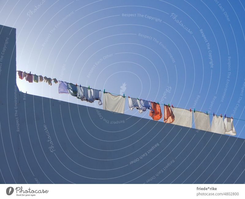 so fresh and so clean // sunlit laundry on a clothesline on a roof terrace Laundry Sunlight Roof terrace Blue sky Sky Baby Wall (barrier) White Spain Clean