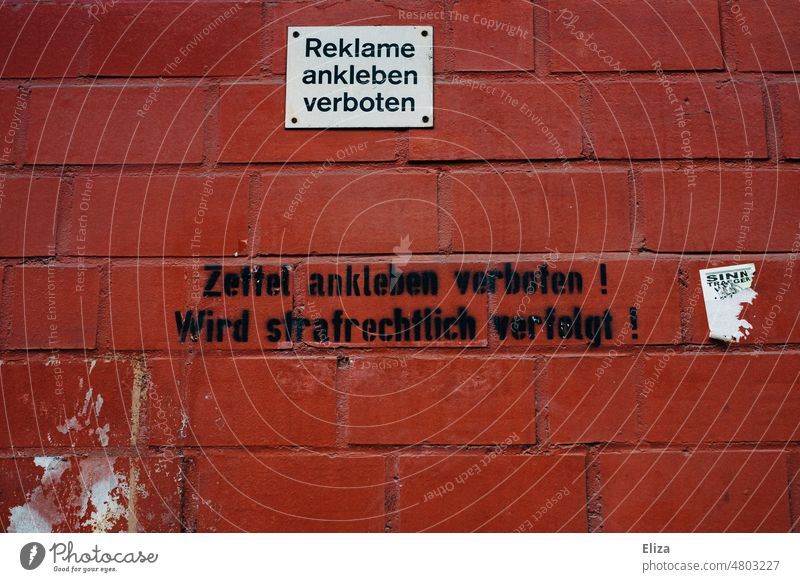 Red brick wall on which is written advertising sticking prohibited advertising prohibited Wall (building) forbidden Text publicity Piece of paper