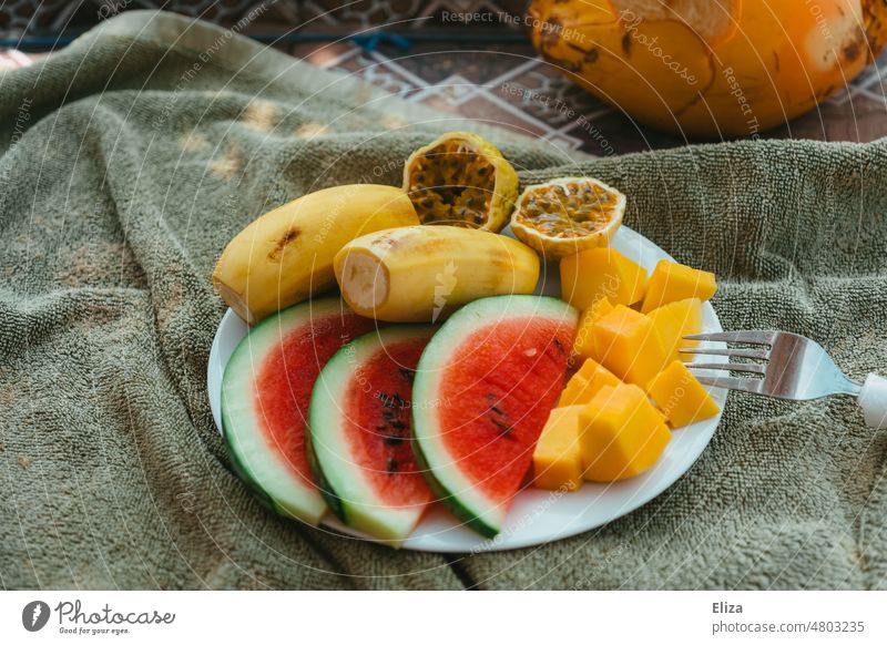 Fruit plate with tropical fruits on towel fruit plate Tropical Water melon Maracuja Passion Fruit Mango Banana salubriously Snack Healthy Eating Plate