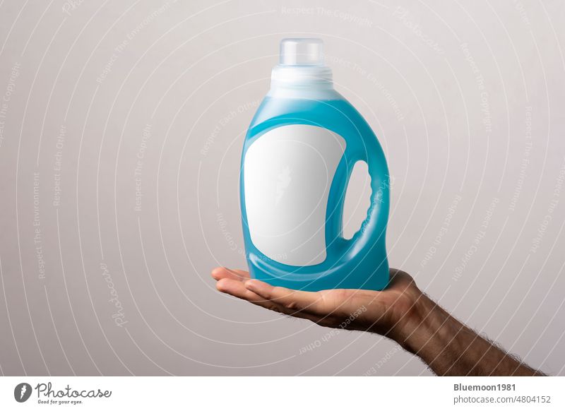 Cloth detergent liquid bottle at male hand mock-up change blank label standing brand clean container design plastic litter object product presentation template