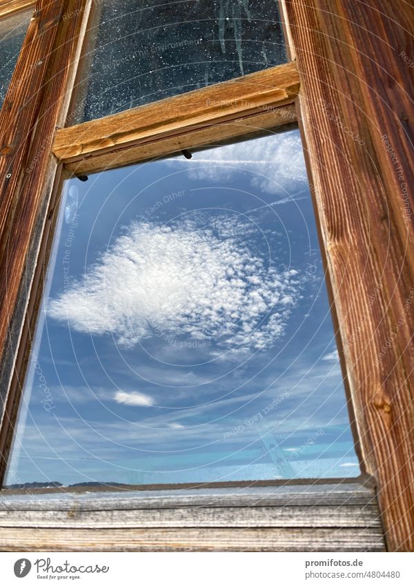 Cloud reflection in the window of a hut in the Allgäu Alps near the Riedberger Horn / Photo: Alexander Hauk Window Hut Sky Blue White Upper Allgäu Bavaria swab