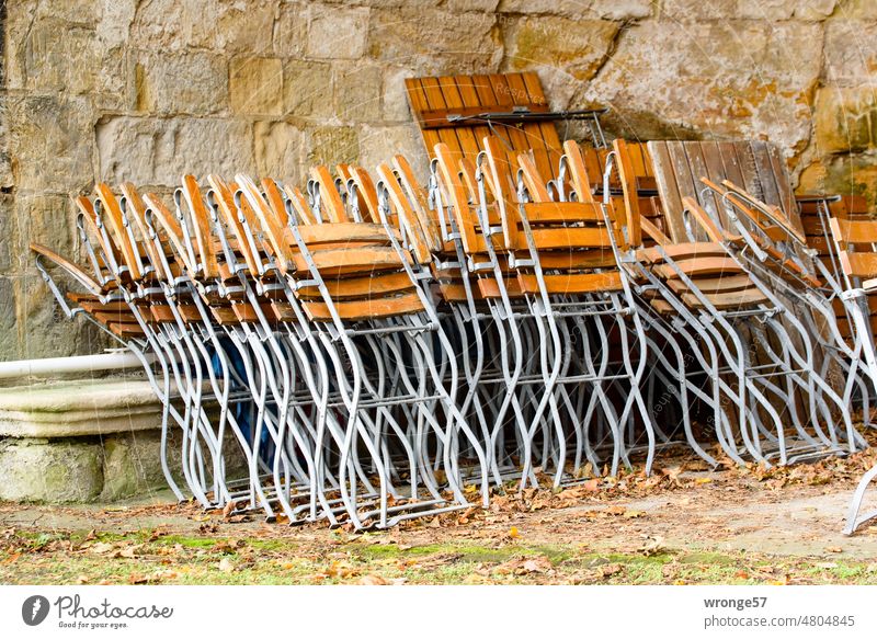 Folded and put away folded placed under Garden chairs defer Summertime End of summer time Empty Deserted Chair Exterior shot Beer garden Colour photo