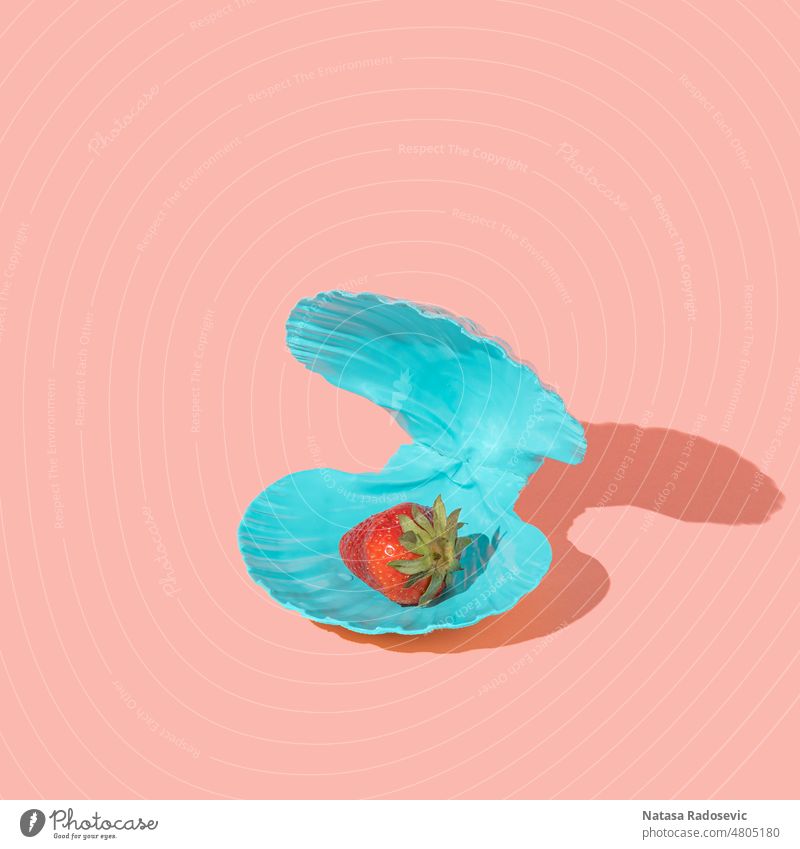 Strawberry in a blue seashell instead of pearl on a pink background. Abstract wallpaper minimal summer Contemporary Isometric Square aesthetic art color image