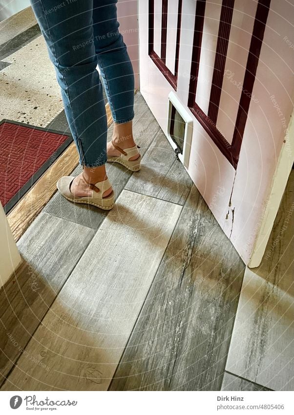 Woman in summer shoes standing in the entrance of an apartment apartment door Staircase (Hallway) Living or residing Entrance House (Residential Structure)