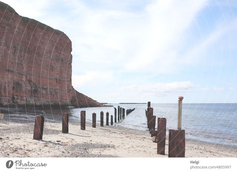 Red rocks on the north side of Helgoland Island North Sea Islands Rock red rocks Sky Ocean Horizon stakes Rock quarry Clouds Spring Light Shadow Tall Nature